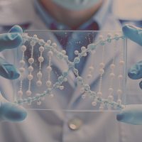 Close up scientist hands holding test tubes with DNA gel. Laboratory worker conducting research in the field of molecular biology. Researcher in blue rubber gloves doing test in laboratory. Background; Shutterstock ID 2431314377; purchase_order: -; job: -; client: -; other: -